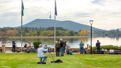 Artists painting on the lawn of Government House overlooking Lake Burley Griffin