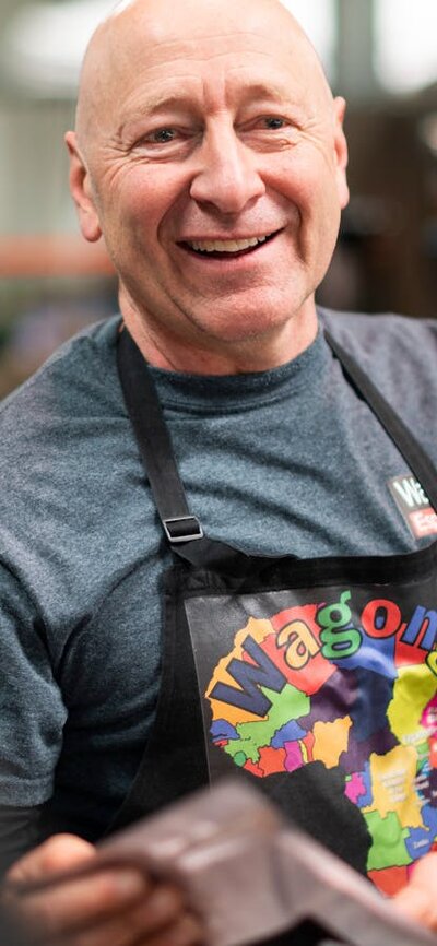 Meet the producers at Capital Region Farmers Market Smiling face of producer Wagonga Coffee at farmers market in Canberra