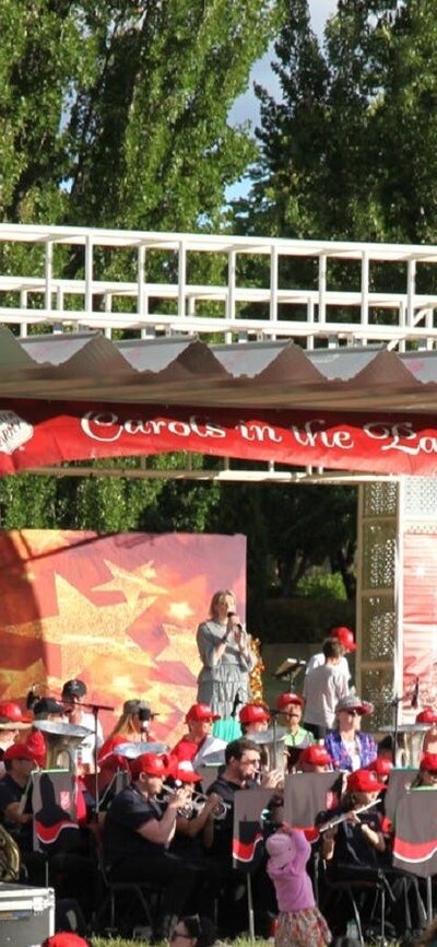 Carollers performing on stage at Carols in Town Park Canberra