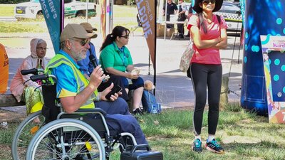 a man in a wheelchair with a microphone