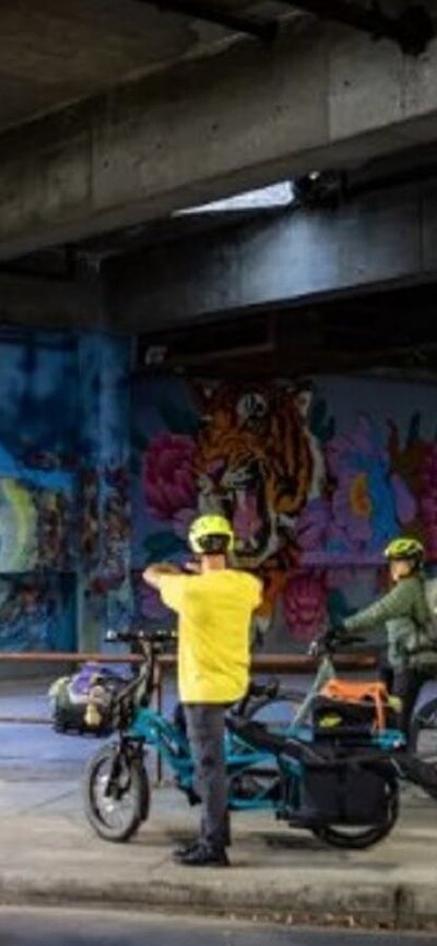 Group of cyclists looking at graffiti wall