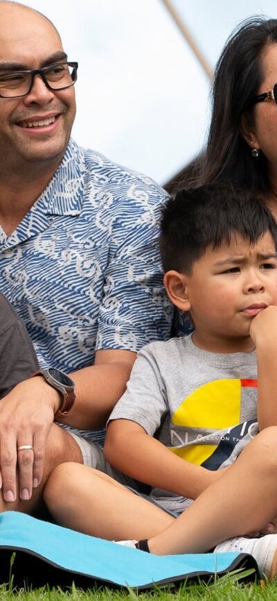 Family enjoying a concert at the lakeside ampitheatre