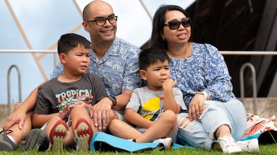 Family enjoying a concert at the lakeside ampitheatre