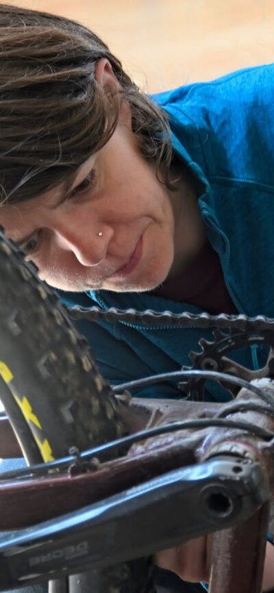 Cyclist checking her bike