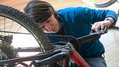 Cyclist checking her bike