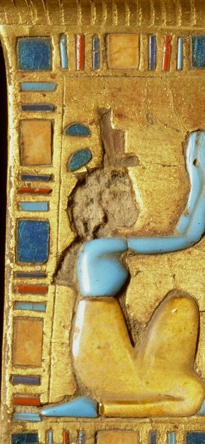 Rectangular gold-coloured plate with a border of brightly-coloured tiles, 2 figures  & a beetle
