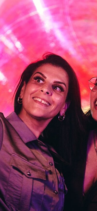 Two females capturing a selfie in front of an Enlighten installation