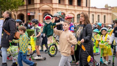 l a street parade, surrounded by other children.