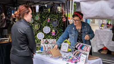 A customer being served at a market stall