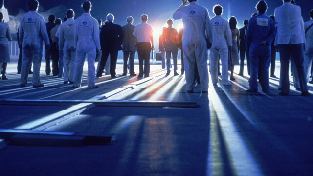 Close Encounters of the Third Kind Blue glowy image with the backs of people standing in white lab coats