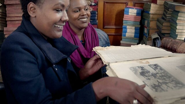 Shiro Koinange and Angela Wachuka Two women reading books in a room full of books and manuscripts
