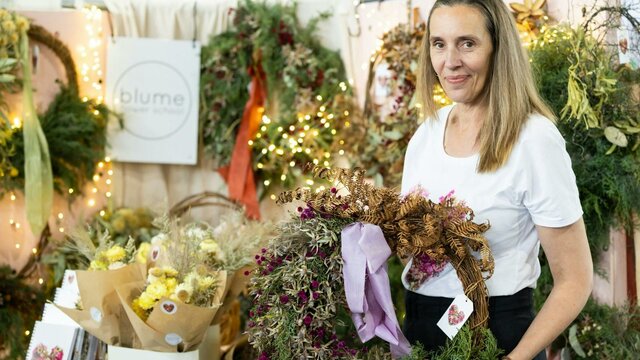 Blume Flower School Blume Flower School holding a wreath