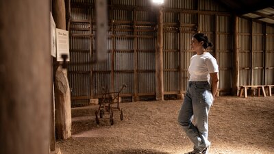 A woman exploring the outbuildings at Lanyon Homestead