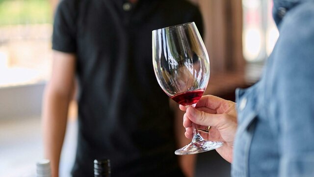 Taste Hilltops wines at the Canberra Cellar Door A glass of red wine is swirled