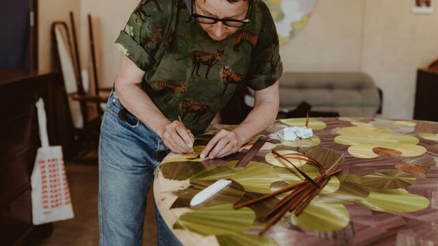 Inke Falkner using the technique of French straw marquetry on her artwork Round and Round
