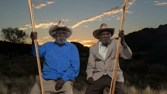 Alec Baker, Yankunytjatjara people, and Kunmanara (Peter) Mungkuri, Yankunytjatjara people, 2017 Two first nations elders in sitting in country near Amaroona at sunset with hand carved spears
