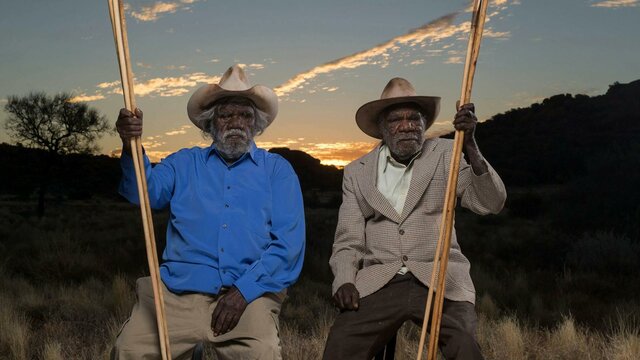 Alec Baker, Yankunytjatjara people, and Kunmanara (Peter) Mungkuri, Yankunytjatjara people, 2017 Two first nations elders in sitting in country near Amaroona at sunset with hand carved spears