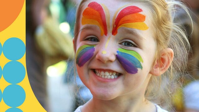 A happy girl enjoying Family Fun Day at the Mint girl with face painted smiling at Family Fun Day at the Mint