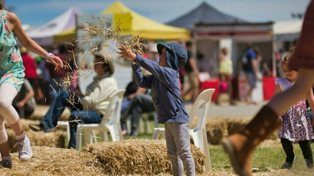 Child throwing straw Child throwing straw
