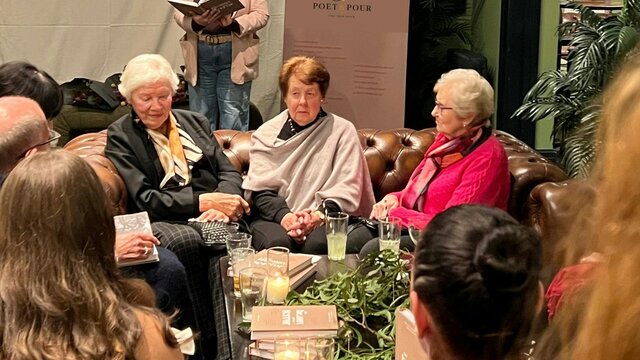 Poet & Pour by Sarah Dee Poetry meets good company Audience listening to a poet speaking from a text