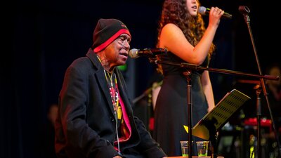 Uncle Archie Roach and young singer-songwriter Layla Barnett perform on stage