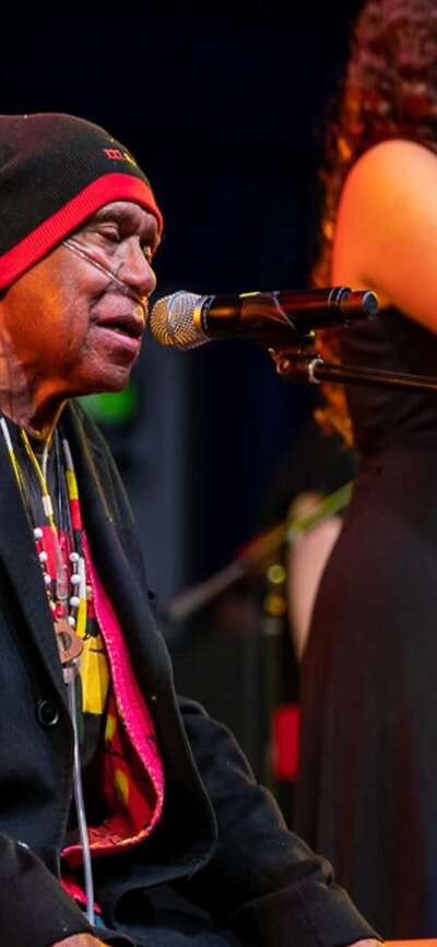 Uncle Archie Roach and Layla Barnett - photo used with the permission of Uncle Archie's family Uncle Archie Roach and young singer-songwriter Layla Barnett perform on stage