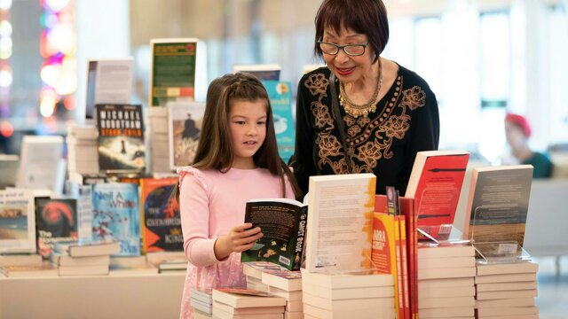 National Library of Australia Bookshop. A woman and young girl looking at books in the National Library of Australia Bookshop