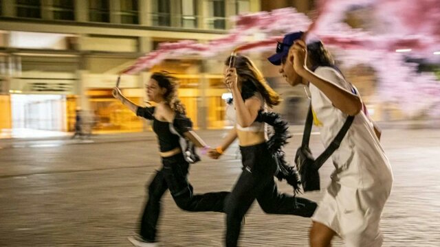Night Walks with Teenagers Bologna 2023 three teenagers running at night with pink flares