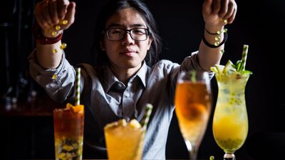 Bartender with four bubble team cocktails