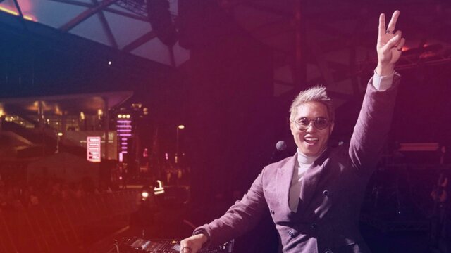SBS PopAsia’s Andy Trieu Andy Trieu doing a live DJ set on stage doing a peace sign