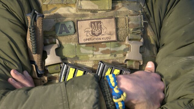 Explore Operation Kudu at the Australian War Memorial Soldier with operation Kudu patch and blue and yellow friendship braclelet