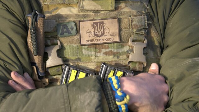 Explore Operation Kudu at the Australian War Memorial Soldier with operation Kudu patch and blue and yellow friendship braclelet