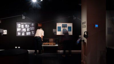 People exploring the Outer Space exhibition by looking closely at objects