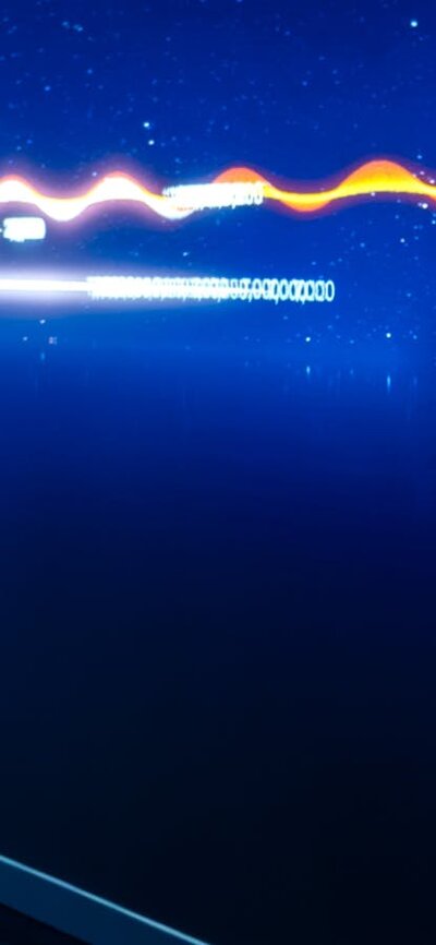 Gravitational Weave, a digital interactive representing the growth of our universe. A young person interacting with Gravitational Weave at Outer Space