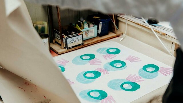 Julia Raath | Open Studio 2025 A photo of a textile print using stamps in round shapes in blue and pink