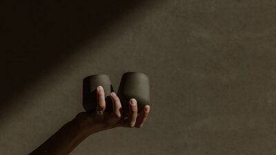 A hand holding 2 ceramic tumblers by Madeline Cardone (STUDIO VESSL)