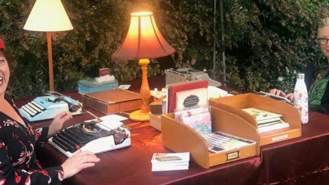 Postscript: letter writing workshop. National Library of Australia. Two women sitting with typewriters and stationery