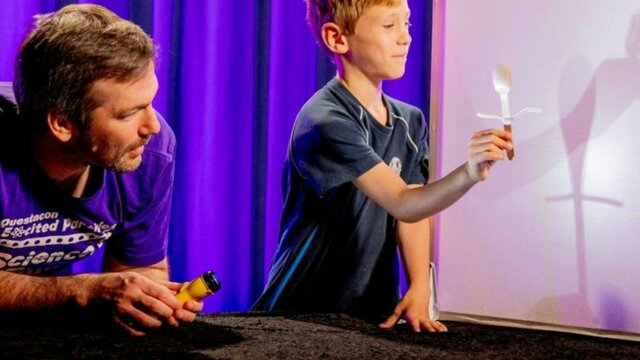 A man and a young boy exploring light in Science Time