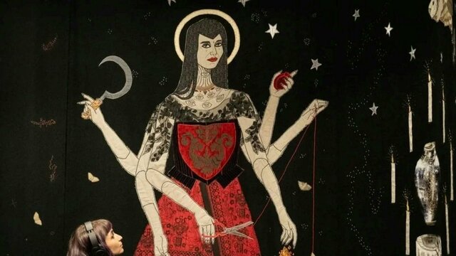 Tal Fitzpatrick | Quietly Seething: Fate, Fury and Transmutation Image of a textile artwork showing a woman standing in a red dress and six arms