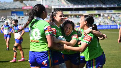 The Raiders NRLW team celebrate a try against the Knights