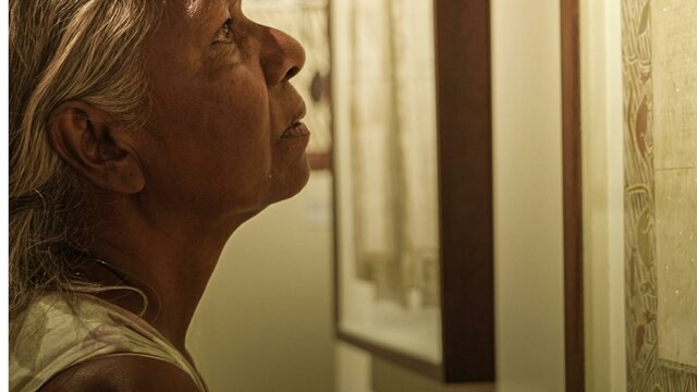 One Mind, One Heart (2024) + Q&A Close up of woman looking intently at an artwork