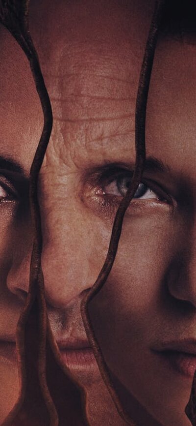 Promotional image for Crimes of the Future showing reflections of three faces