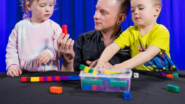 Two children and a man explore patterns using coloured blocks Two children and a man explore patterns using coloured blocks