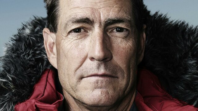 Headshot of Professor John Priscu in a red, weatherproof jacket with hood,