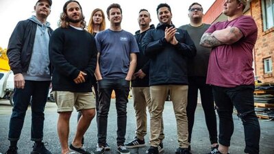 Group of people standing on bitumen