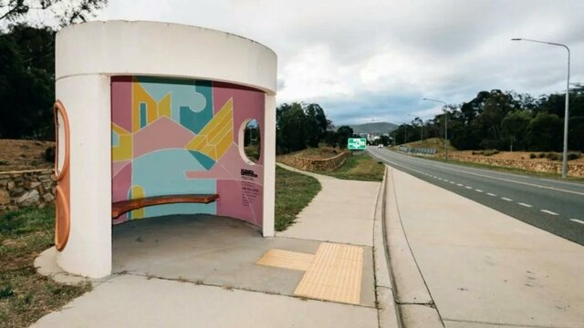 Bus Stop, Chelsea Lemon, 2018 A picture of A Canberra Bus Stop with A painted internal artwork with blue yellow and pink