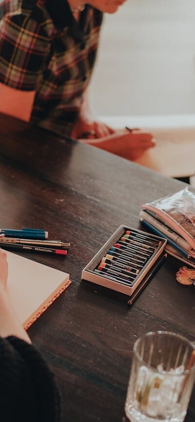 People sitting around a table with pencils and paper