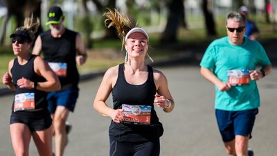 Woman smiling and running towards the camera