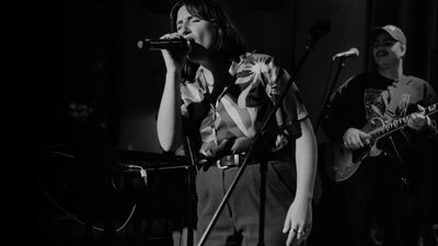 Woman singing into microphone