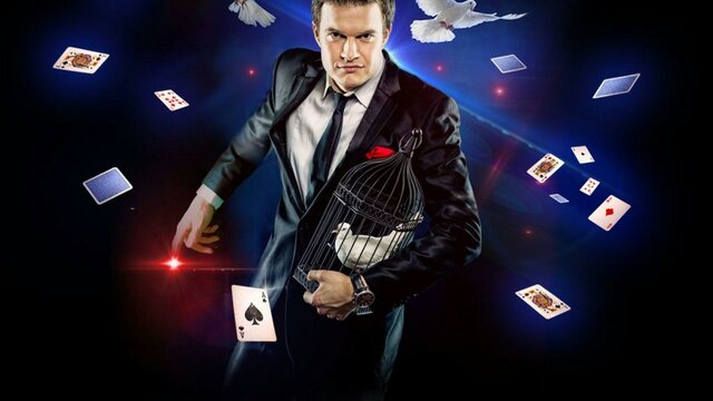 a magician with white doves flying above him with Playing cards falling around him.